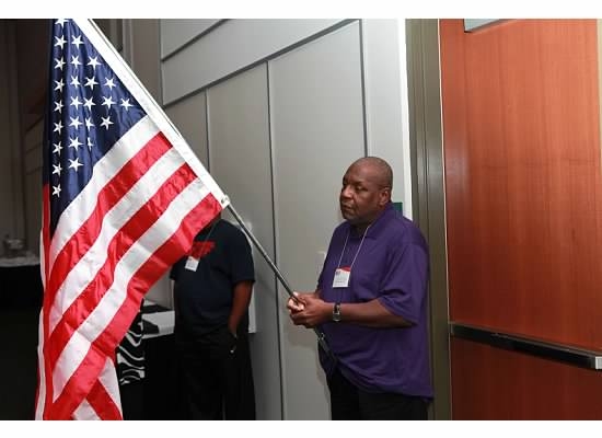 Melvin Gillyard carrying the U.S. Flag which was flown over the U.S. Capitol on July 4, 2012