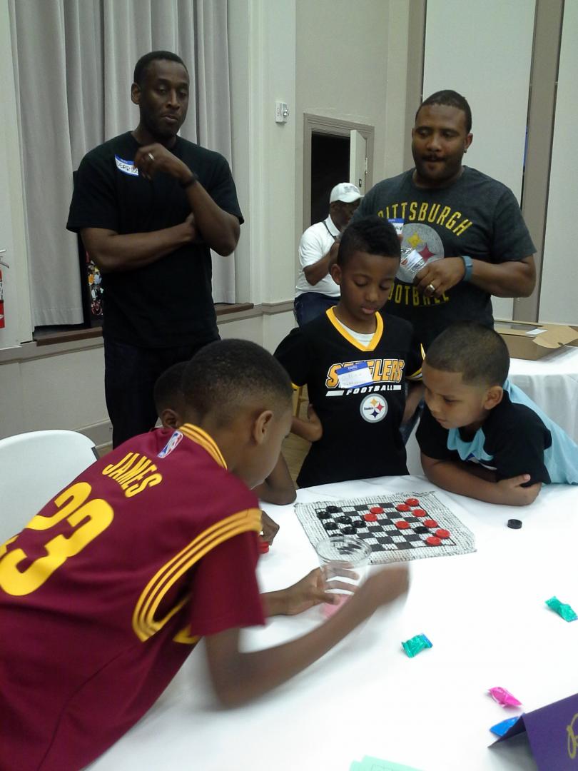Family youth playing checkers